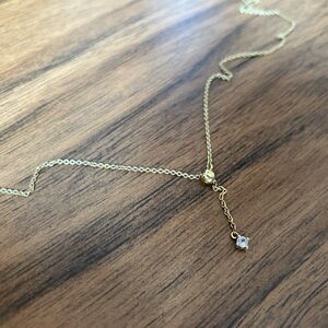 Lariat slide necklace by Mejuri; gold vermeil and white sapphire; dainty